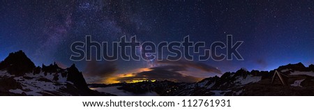 Extraordinary 360 degree panorama of the night sky in the Swiss alps at 2700+ meters. Visible is a glow from a city and the majestic milky way above it