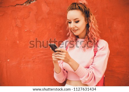 young pretty woman posing in the street with phone, outdoor portrait, hipster girls, sisters, chic, tablet, internet, using smartphone, close-up fashion model, post in instagram, facebook, street