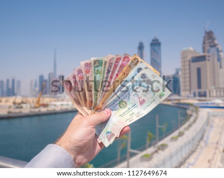 A man holds the money of the United Arab Emirates. Dirham.