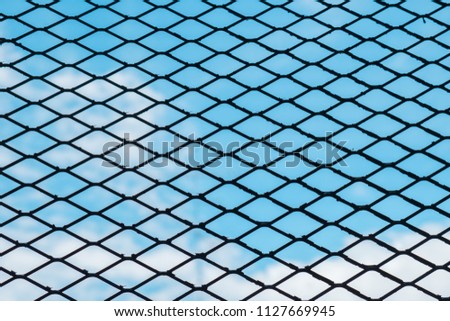 Steel mesh with bright sky background
