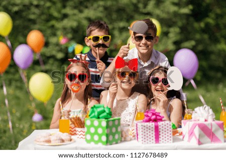 holidays, childhood and celebration concept - happy kids with party props at summer birthday