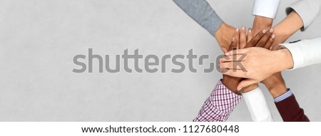 business startup and teamwork concept - diverse team putting their hands together Royalty-Free Stock Photo #1127680448