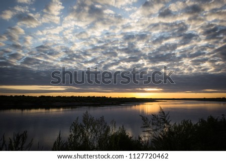 There was a beautiful sundown near to siberian river.