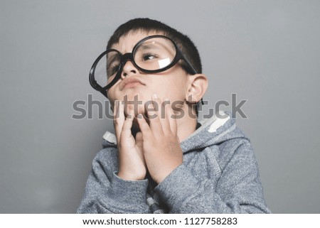 thinking, boy with big glasses very serious and thinking