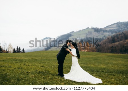 Wonderful bride and groom on the green field