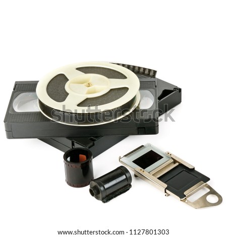 Video cassettes, film and slides isolated on white background. Retro cinema equipment.