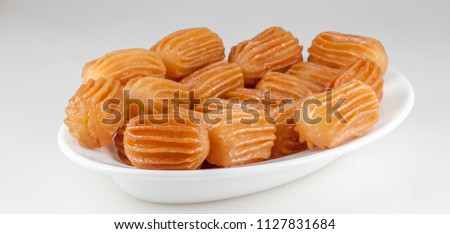 balah al sham ( Arabian sweet contains Potato paste mixed with water and fried in deep oil , then covered with honey) Royalty-Free Stock Photo #1127831684