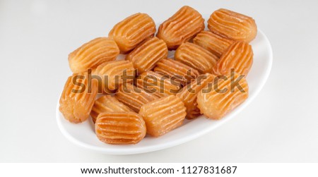 balah al sham ( Arabian sweet contains Potato paste mixed with water and fried in deep oil , then covered with honey) Royalty-Free Stock Photo #1127831687