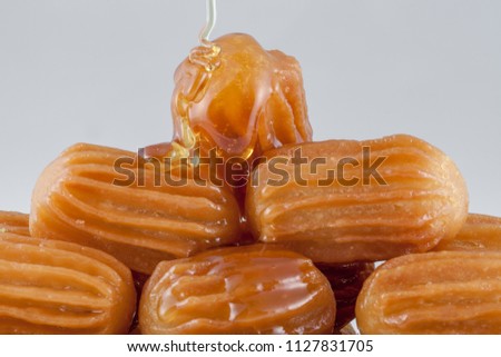 balah al sham ( Arabian sweet contains Potato paste mixed with water and fried in deep oil , then covered with honey) Royalty-Free Stock Photo #1127831705