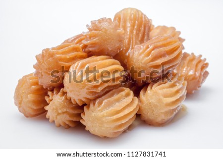 balah al sham ( Arabian sweet contains Potato paste mixed with water and fried in deep oil , then covered with honey) Royalty-Free Stock Photo #1127831741