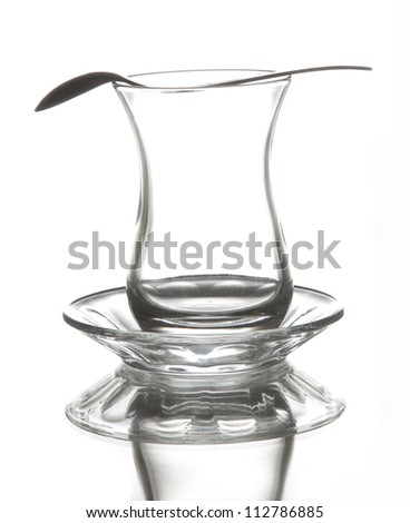 Turkish tea glass on white background with metal spoon