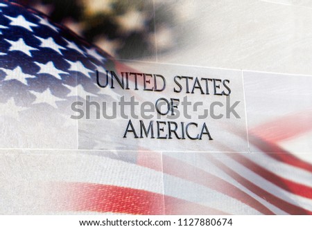 United States of America Building sign with an American flag behind it