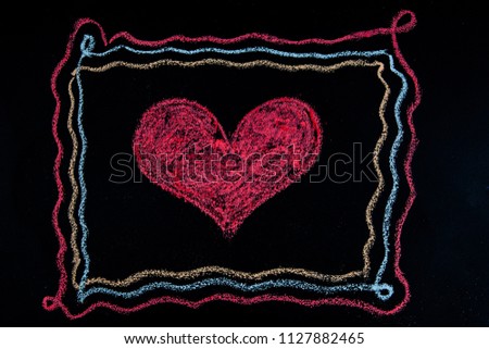 Chalk on blackboard drawing - heart shape inside a frame - love, relationship, and valentine's day concept