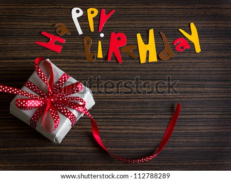 Vintage gift box (package)with words happy birthday on  wooden background/Sweet holiday background.