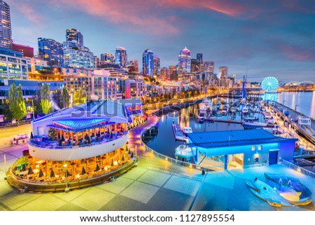 Seattle, Washington, USA pier and skyline at dusk.