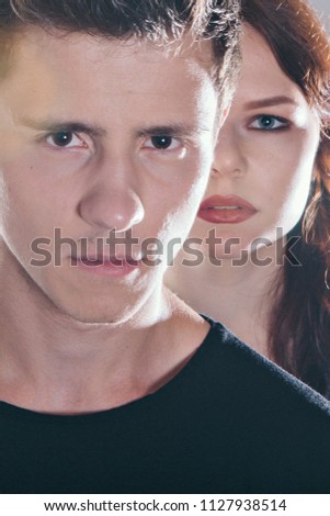 Cropped image of a beautiful couple looking at the camera standing right