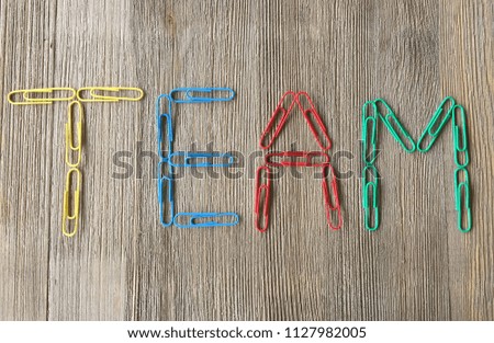 Team - Word Spelled out on wood background
