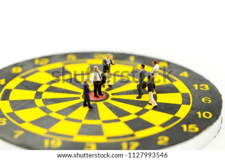 Miniature people : leader and business owner,boss at the target on dart board, concept of success.