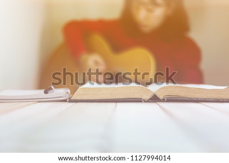 Young woman christian playing guitar worship to Lord with the bible, Devotion concept.
