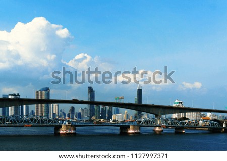 Bridge over the river and cloud blue sky view of Bangkok skyline and skyscraper