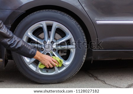 A girl is cleaning her car