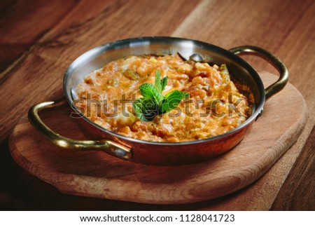 Traditional turkish food menemen made by eggs and tomatoes. Royalty-Free Stock Photo #1128041723