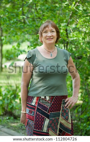 Outdoor portrait of smiling mature woman