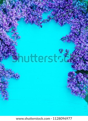 Decorative frame of lilac flowers and space for text. Lilac background
