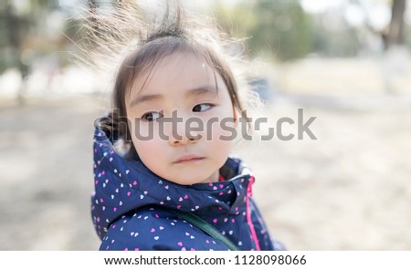 An outdoor portrait of a lovely little asian girl