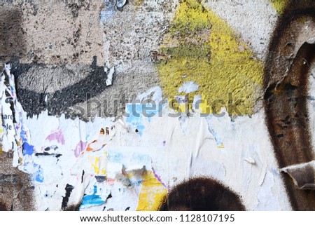 concrete wall with graffiti, ripped torn weathered grungy urban street poster