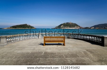 bench located on the beach of La Concha with views of the bay, the island of Santa Clara and Mount Urgull