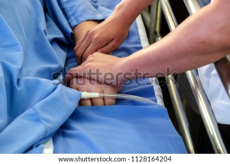Concept Picture of Woman Touching Sick Man with Encouragement Hands.