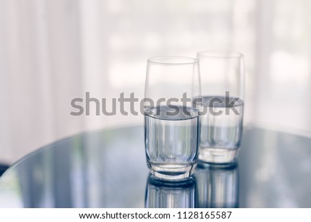Two glasses of mineral water on the table  Royalty-Free Stock Photo #1128165587