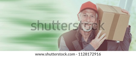 Portrait of smiling senior deliverer holding a package