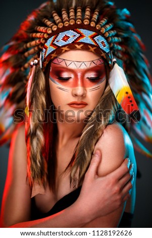 Young feminine Indian American female with colorful feather hat