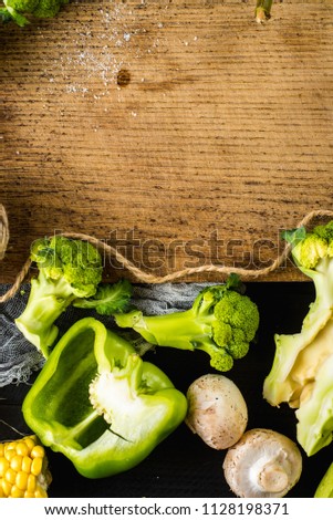 Many different of green ripe vegetables on wooden background. Copy space