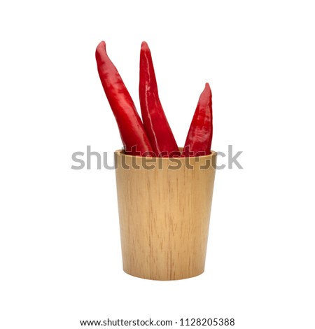 Red Chillies in wooden cup isolated white background