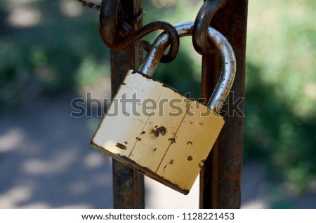 Picture of a rusty padlock on a fence