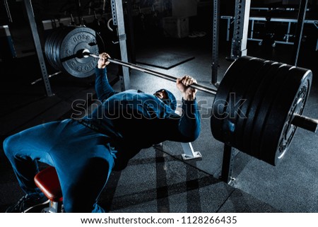Strong man working heavy im gym Royalty-Free Stock Photo #1128266435
