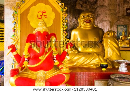 Golden Buddha and red Ganesha in Tiger Cave Temple, Wat Tham Suea in Thailand