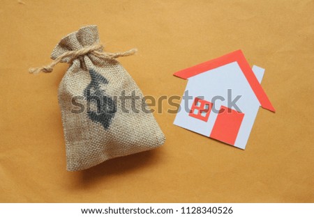 Paper cut of house red roof on brown background with money bag,top view. 