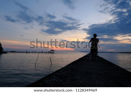 Silhouette of Photographer was capturing a moment of sunset in Port Dickson, Malaysia