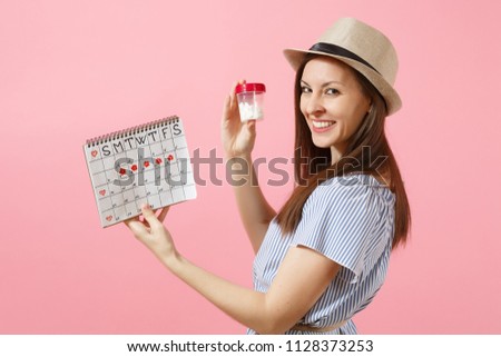 Portrait of young woman in blue dress holding bottle with white pills, female periods calendar, checking menstruation days isolated on background. Medical healthcare gynecological concept. Copy space