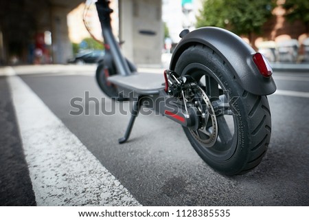 Electric scooter on the road Royalty-Free Stock Photo #1128385535