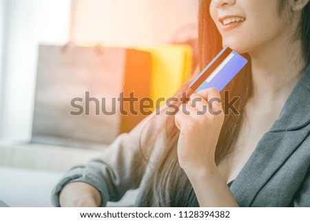 Young woman holding credit card. Online shopping concept.Beautiful young woman smiling holding shopping card.
