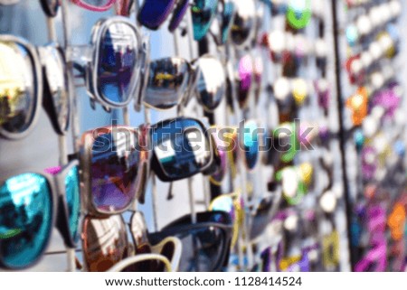 Abstract blurred sunglasses. Colorful sunglasses on display background.