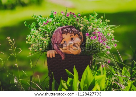 Cute little gnome garden model, summer decorative statue, outdoor sculpture, fantasy figure in grass