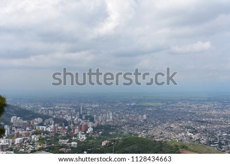 View over the city santiago de cali colombia from the top of a mountain next to the Cristo Ray. 