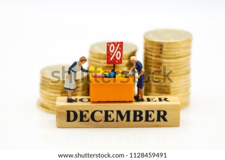Miniature people : Shopper with shopping discount items, month of sale. Image use for Business and shopping concept.