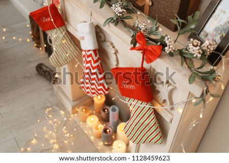 Decorative fireplace with Christmas stockings in living room